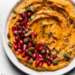 10-Minute Cozy and Creamy Pumpkin Hummus served in a bowl