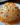 Bacon Cheddar Ranch Cheese Ball garnished with nuts on a wooden platter