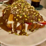 Belgian chocolate cream-filled croissant with banana and strawberry on a plate