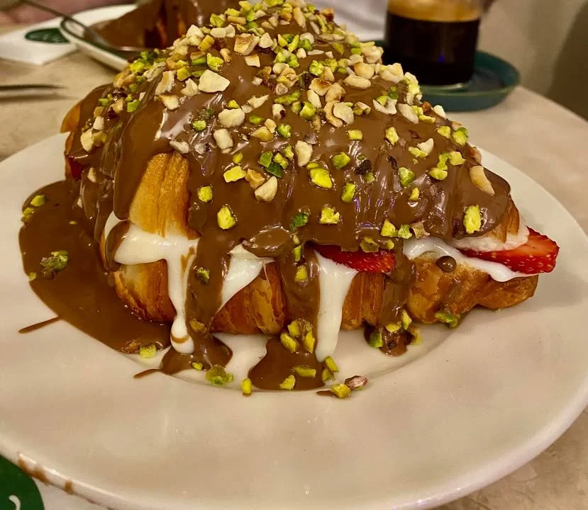 Belgian chocolate cream-filled croissant with banana and strawberry on a plate