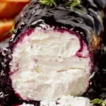 Blueberry goat cheese on a serving platter with fresh berries.