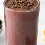 Delicious cacao smoothie in a glass with a sprinkle of cacao powder on top
