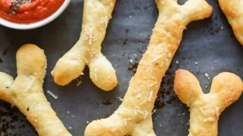 Cheesy Halloween breadstick bones shaped like spooky skeletons