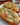 Cheesy lobster garlic bread topped with herbs and cheese, ready to serve.