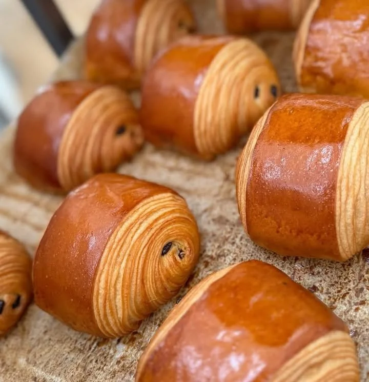 Golden brown croissant freshly baked, showcasing flaky layers and pastry perfection.