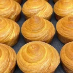 Freshly baked croissant by Chef Broich, showcasing layers of buttery pastry.