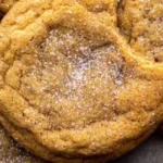 Freshly baked chewy pumpkin cookies on a wooden tray