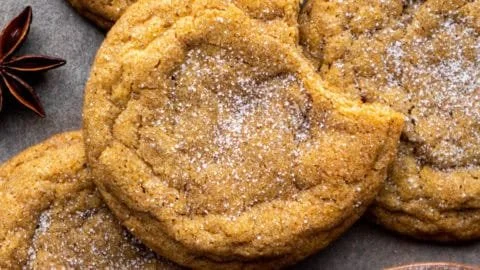 Freshly baked chewy pumpkin cookies on a wooden tray