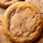 Chewy pumpkin snickerdoodle cookies on a plate with a sprinkle of cinnamon