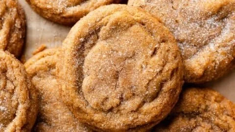 Chewy pumpkin snickerdoodle cookies on a plate with a sprinkle of cinnamon