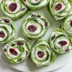 Delicious Christmas Cranberry Pinwheels served on a festive platter.
