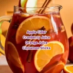 Cinnamon Apple Punch mocktail in a glass with apple slices and cinnamon sticks