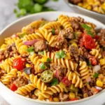 Colorful Cowboy Pasta Salad with vegetables and dressing in a bowl