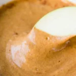 Dairy-free pumpkin pie dip served in a bowl with a sprinkle of cinnamon on top