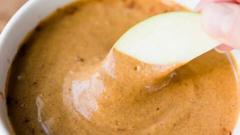 Dairy-free pumpkin pie dip served in a bowl with a sprinkle of cinnamon on top