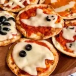 Easy mini Halloween pizzas shaped like ghosts and pumpkins