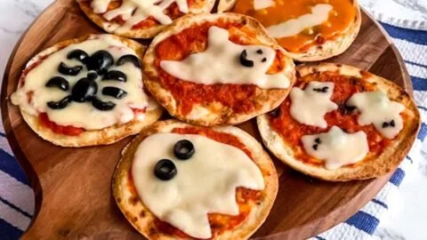Easy mini Halloween pizzas shaped like ghosts and pumpkins
