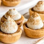 Delicious easy mini pumpkin pies served on a wooden table.