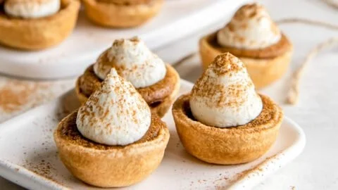 Delicious easy mini pumpkin pies served on a wooden table.
