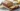 Slice of easy moist banana bread on a wooden cutting board