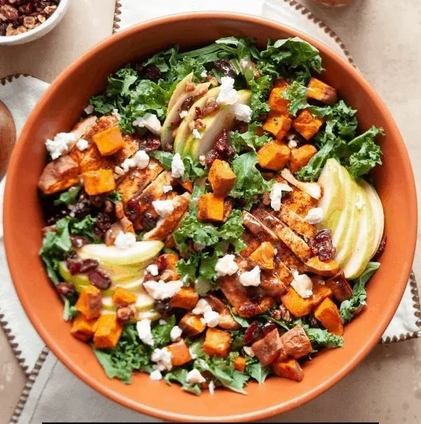 A colorful Fall Harvest Salad with seasonal ingredients like cranberries, nuts, and mixed greens.