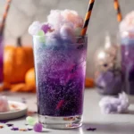 Colorful Fizzy Purple Potion Halloween Punch in a spooky drink dispenser