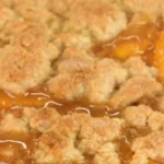 Fresh Southern peach cobbler with a flaky crust and sweet peaches.
