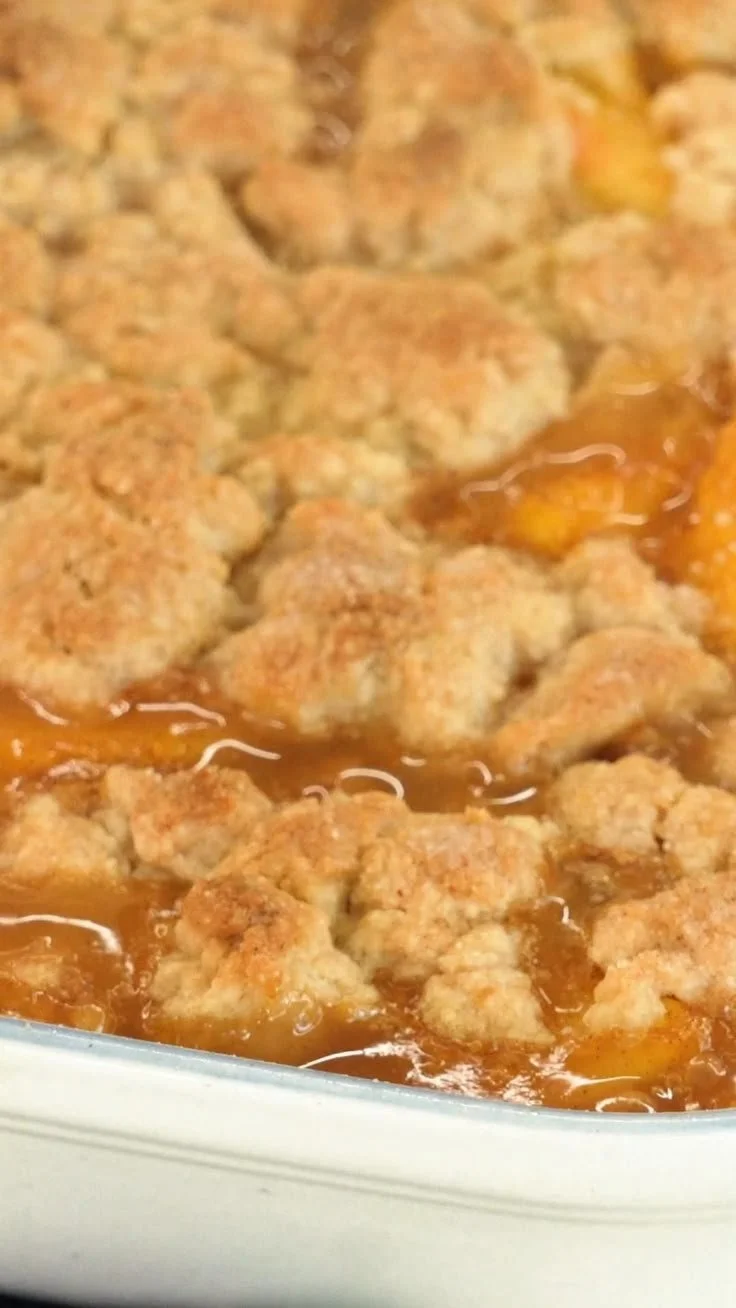 Fresh Southern peach cobbler with a flaky crust and sweet peaches.