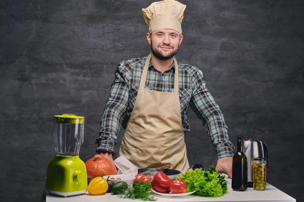 Portrait of Chef Luca Moretti, founder of MyDrinksY, smiling in a professional kitchen setting.