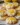 Gluten-free lemon curd cookies stacked on a plate with lemon slices