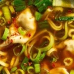 Bowl of Gyoza Soup with dumplings and vegetables