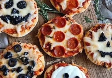 Halloween-themed mini pizzas with spooky toppings for a festive celebration