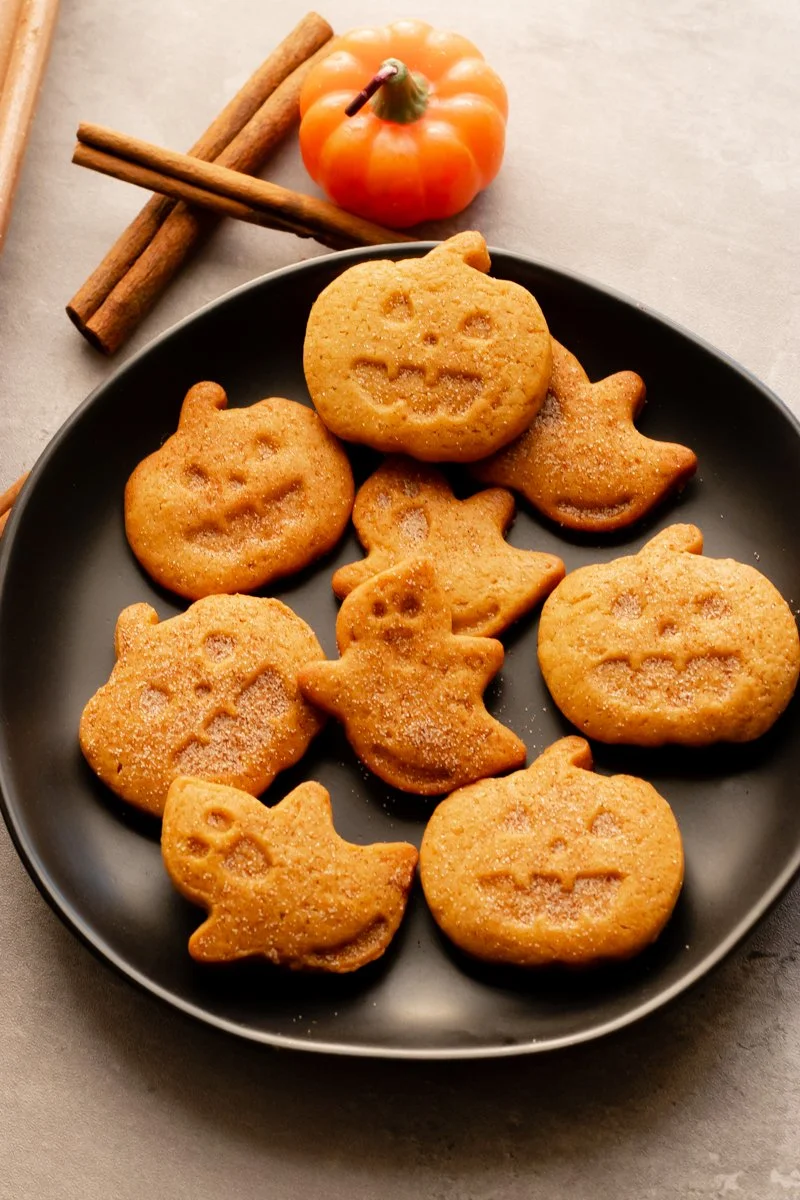 Vegan Halloween pumpkin spice cookies topped with seasonal spice decorations