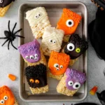 Colorful Halloween Rice Krispie Treats shaped like ghosts and pumpkins