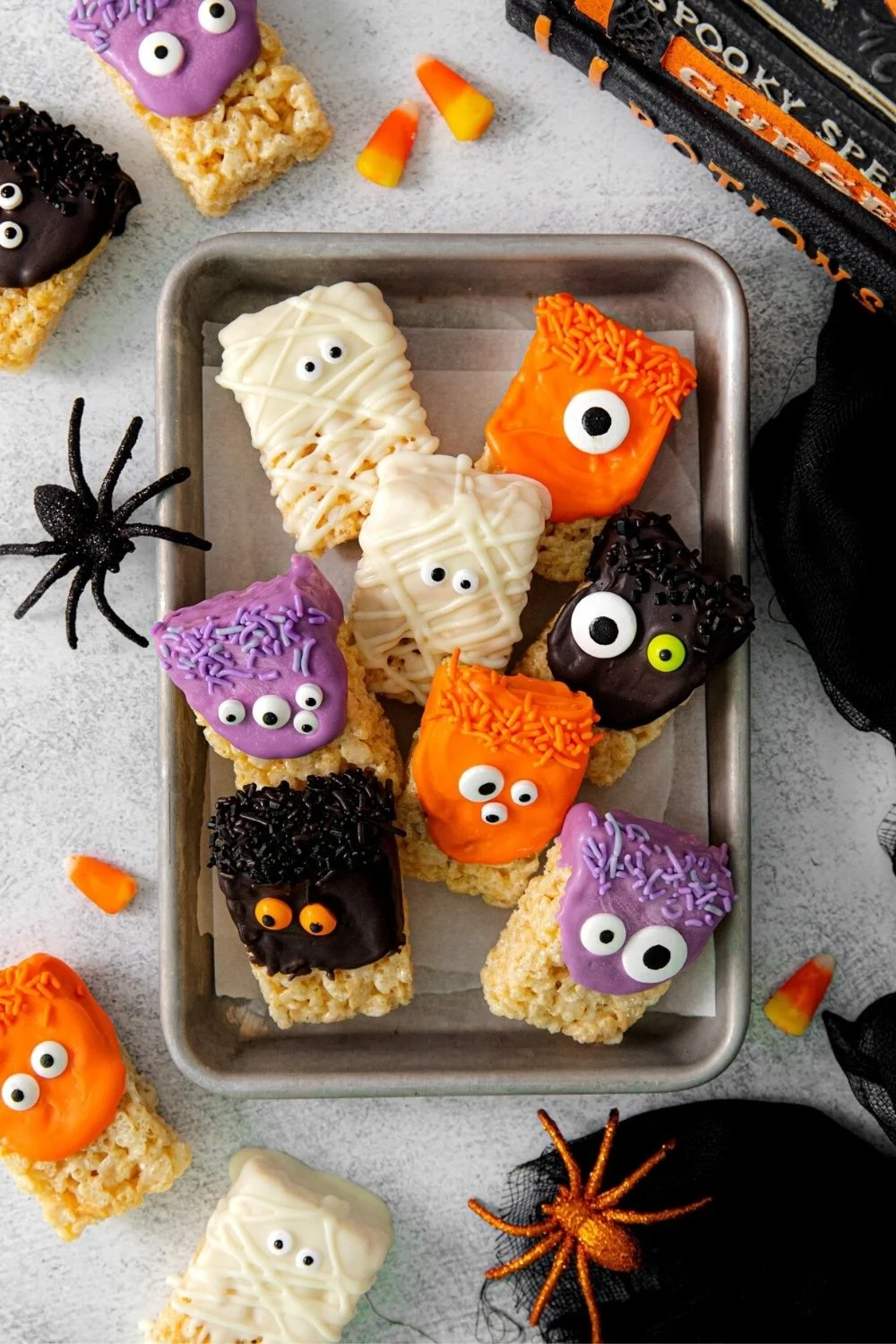 Colorful Halloween Rice Krispie Treats shaped like ghosts and pumpkins