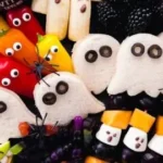 Colorful Halloween snack board for kids with spooky treats and festive decor.
