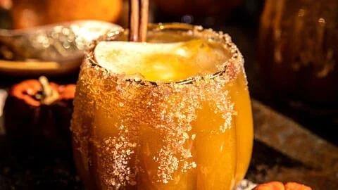 Haunted Pumpkin Patch Margarita cocktail with pumpkins in the background