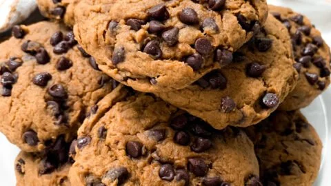 Delicious healthy pumpkin chocolate chip cookies on a rustic wooden table.