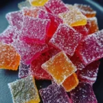 Colorful homemade rhubarb sour candy on a plate.