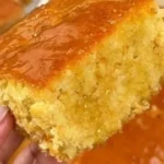 A delicious slice of Honey Butter Cornbread served with honey and butter.