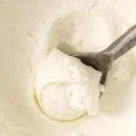 Homemade cream cheese preparation process in a kitchen