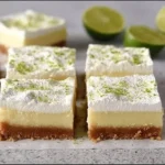 Delicious Key Lime Pie Bars served on a white plate with lime garnish