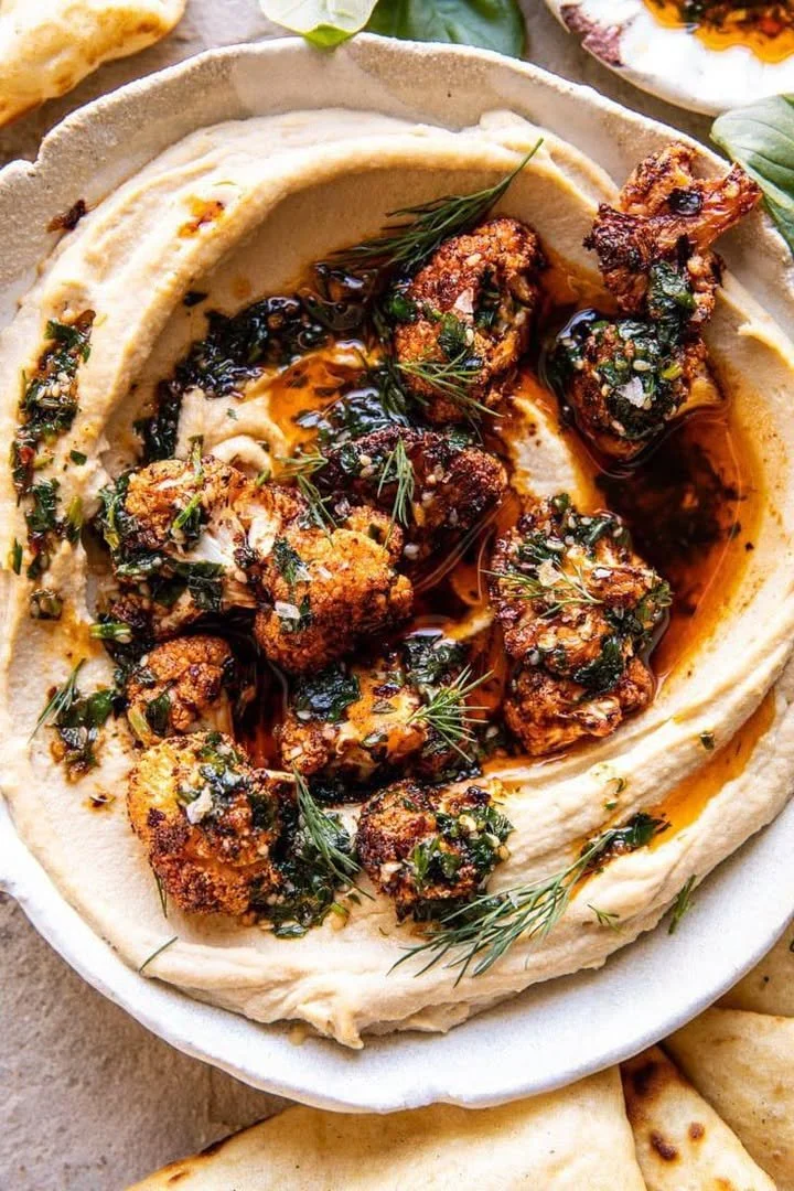 Bowl of Mediterranean Crispy Roasted Cauliflower Hummus with pita and veggies