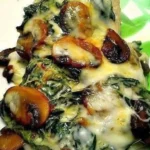 Mediterranean spinach and mushroom smothered chicken on a plate