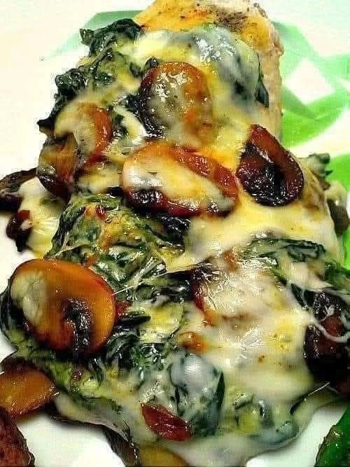 Mediterranean spinach and mushroom smothered chicken on a plate