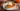 A freshly baked perfect pumpkin pie topped with whipped cream and cinnamon.