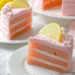 Delicious pink lemonade cake with fresh pink frosting and lemon slices on top