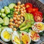 Protein-packed chicken egg salad in a bowl with fresh vegetables