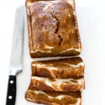 Loaf of Pumpkin Cream Cheese Bread with spices and frosting on top