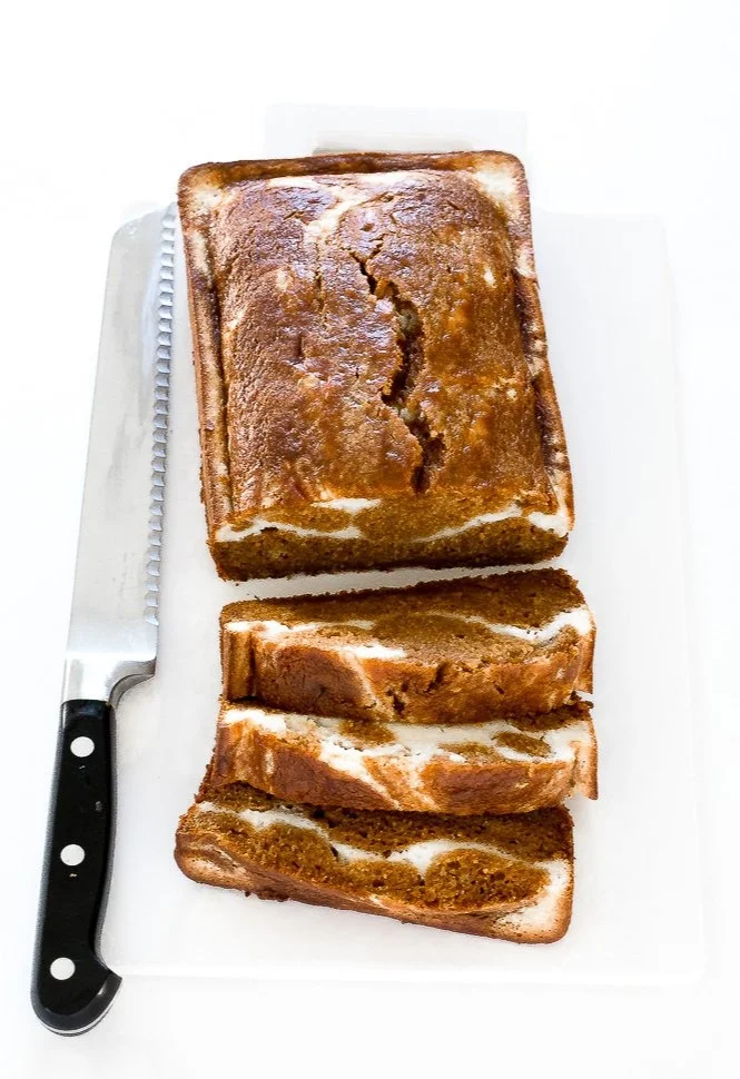 Loaf of Pumpkin Cream Cheese Bread with spices and frosting on top